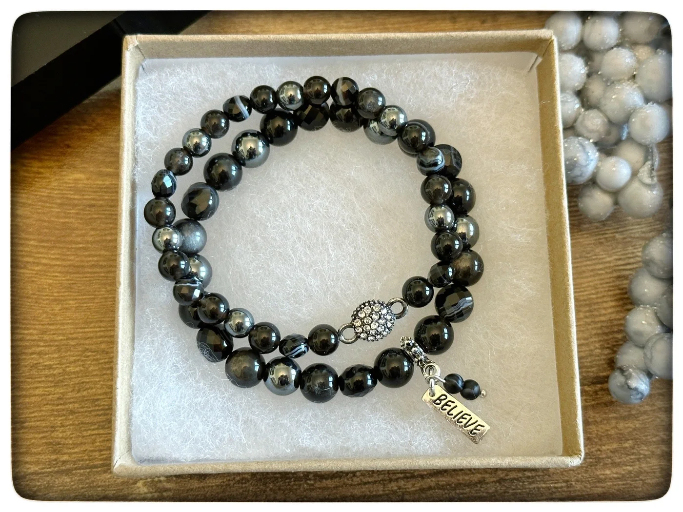 Dark green and black beaded charm bracelet in a gift box