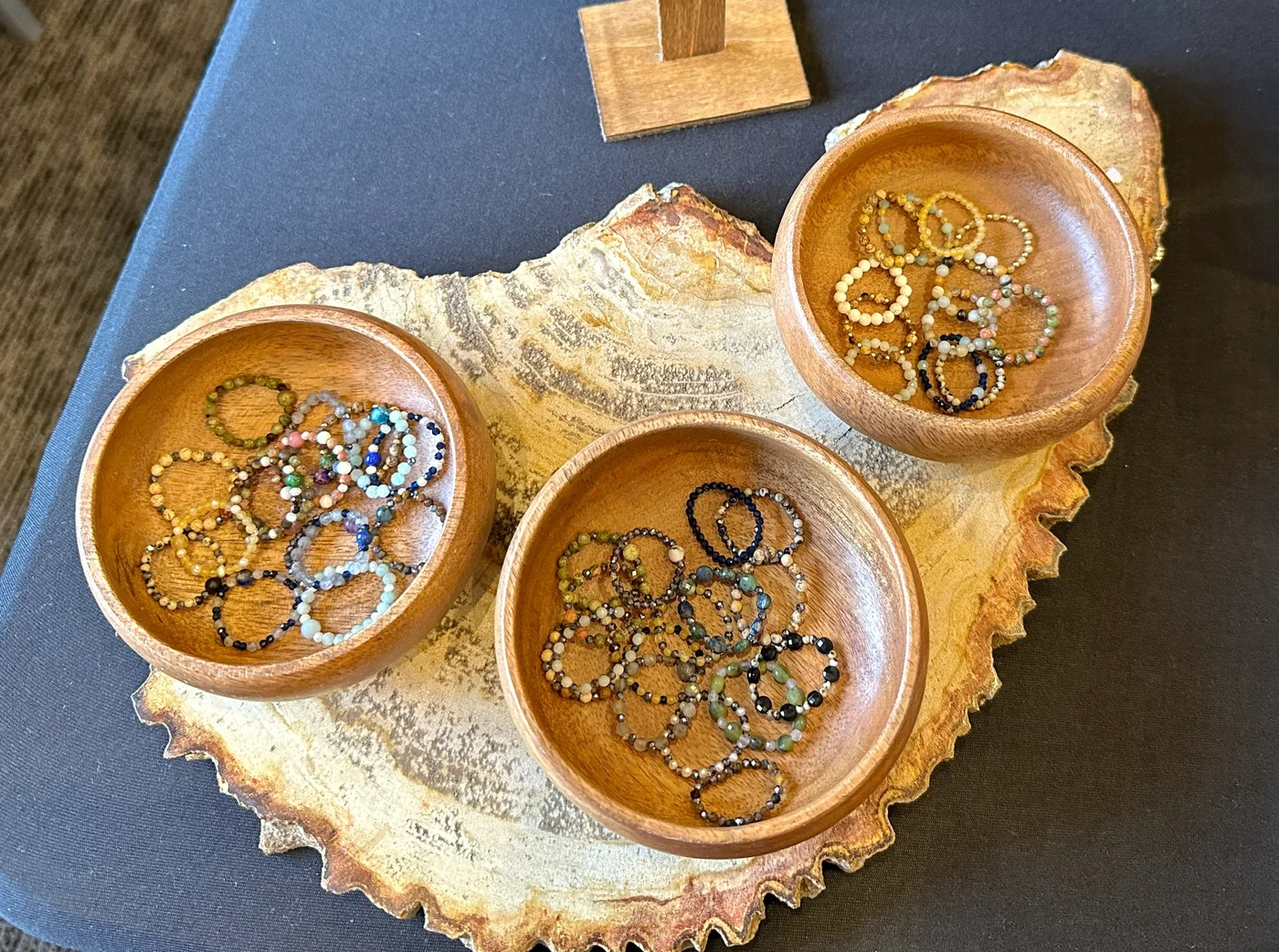 Assorted gemstone rings displayed in a decorative shell-shaped dish
