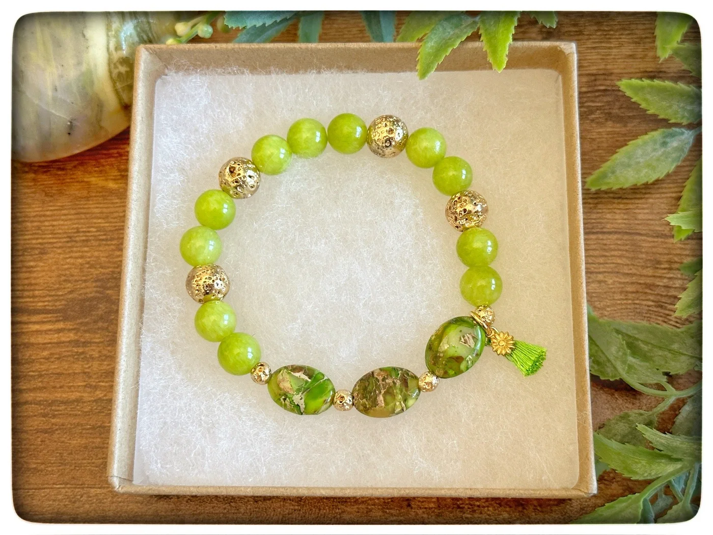 Bright green beaded bracelet with patterned round accents