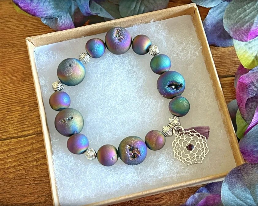 A purple and teal Rockin’ Intentions charm bracelet in its gift box